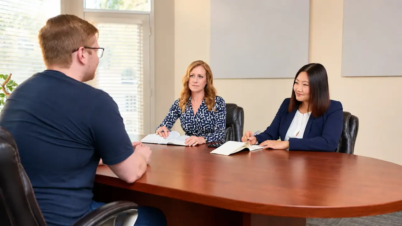 BV Law lawyers meeting with a client in the firm's boardroom