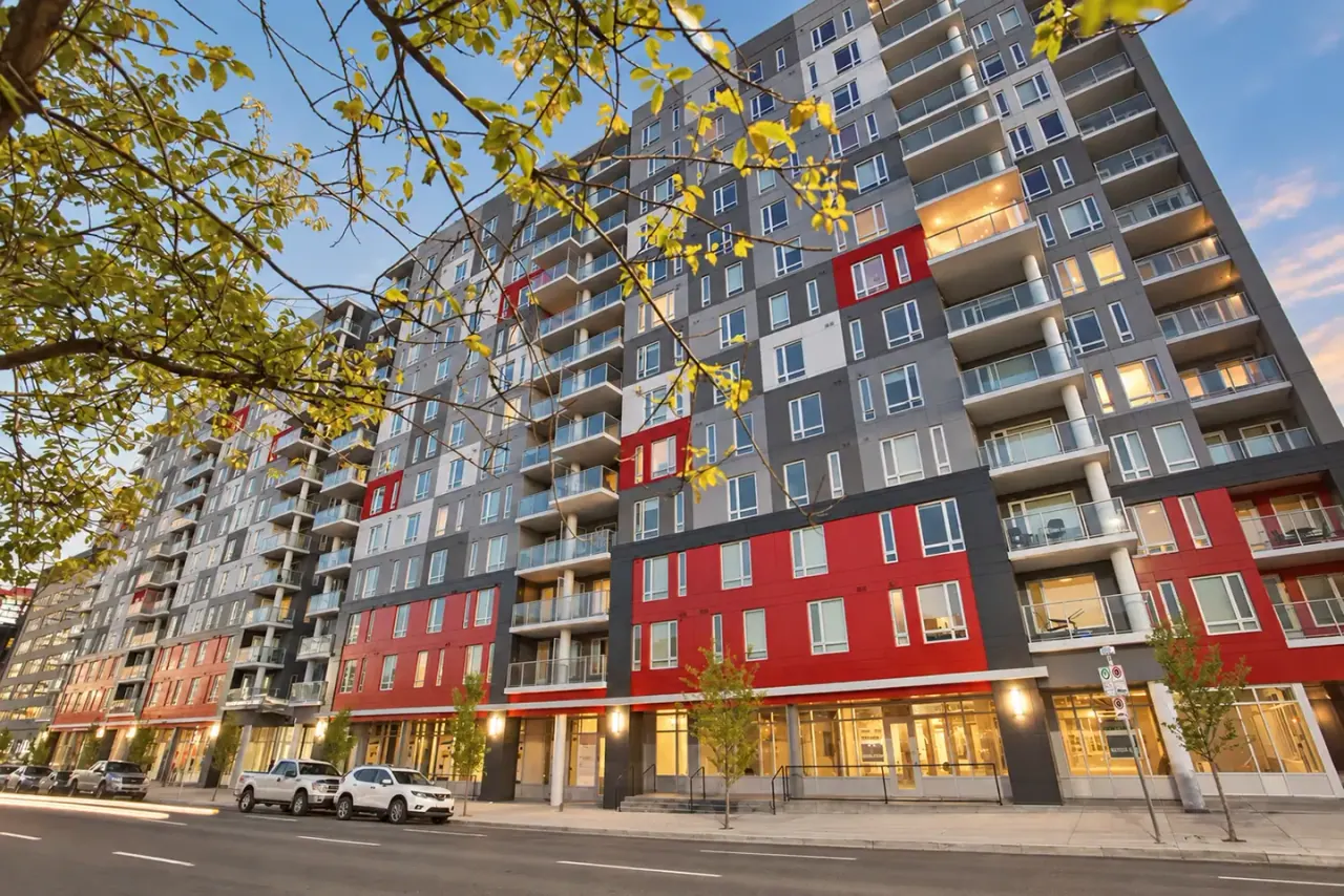 The Metropole's red and grey facade framed by trees
