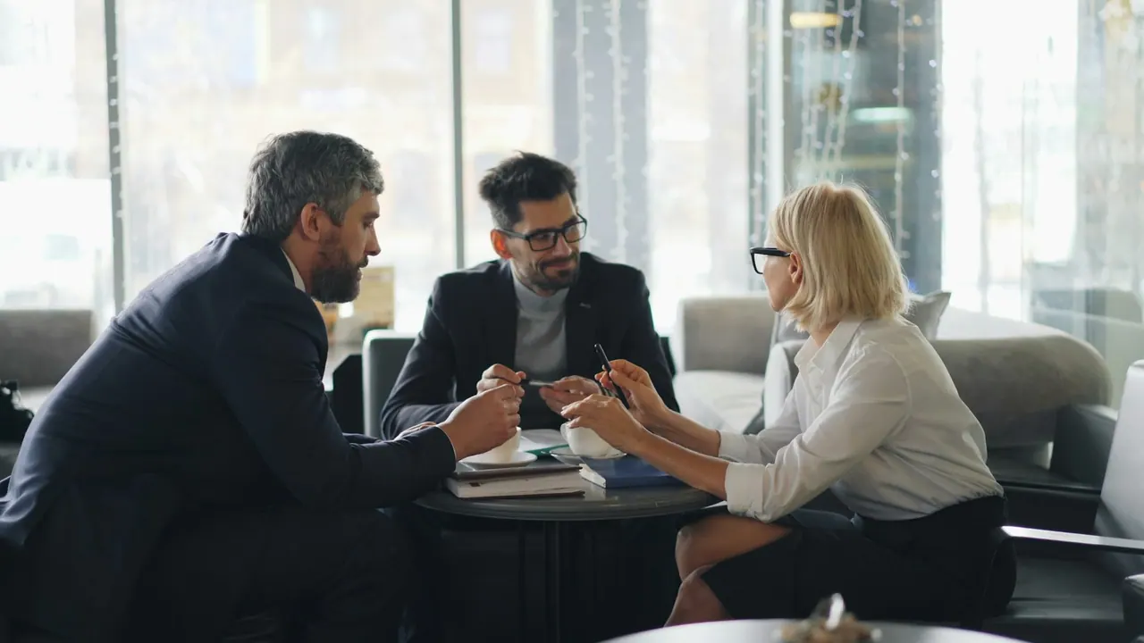 The team around a table in a bright office, talking through a client file