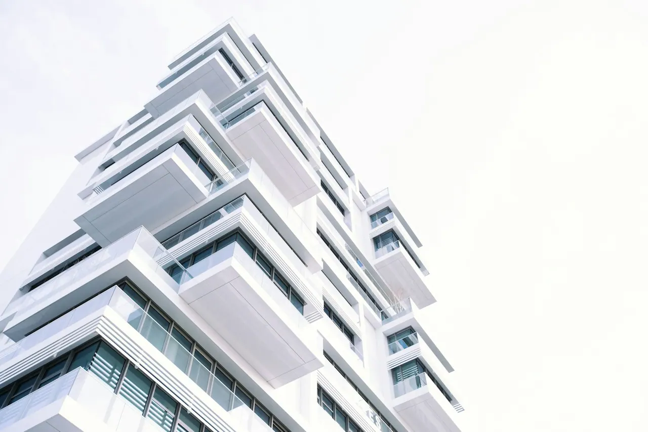 A white condo tower with stacked balconies