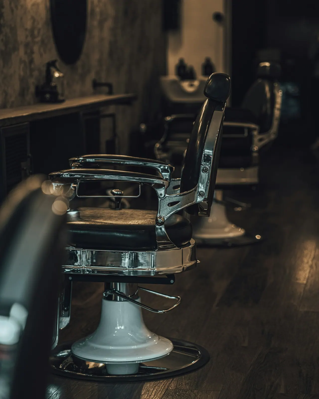 A chrome and leather barber chair in a quiet shop