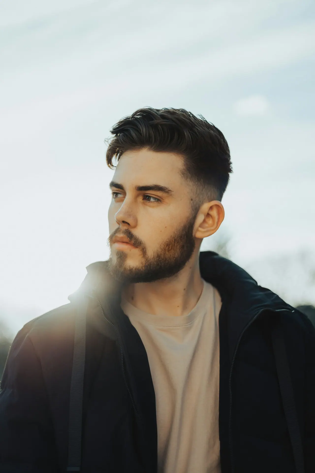 A young man with a fresh short crop and trimmed beard