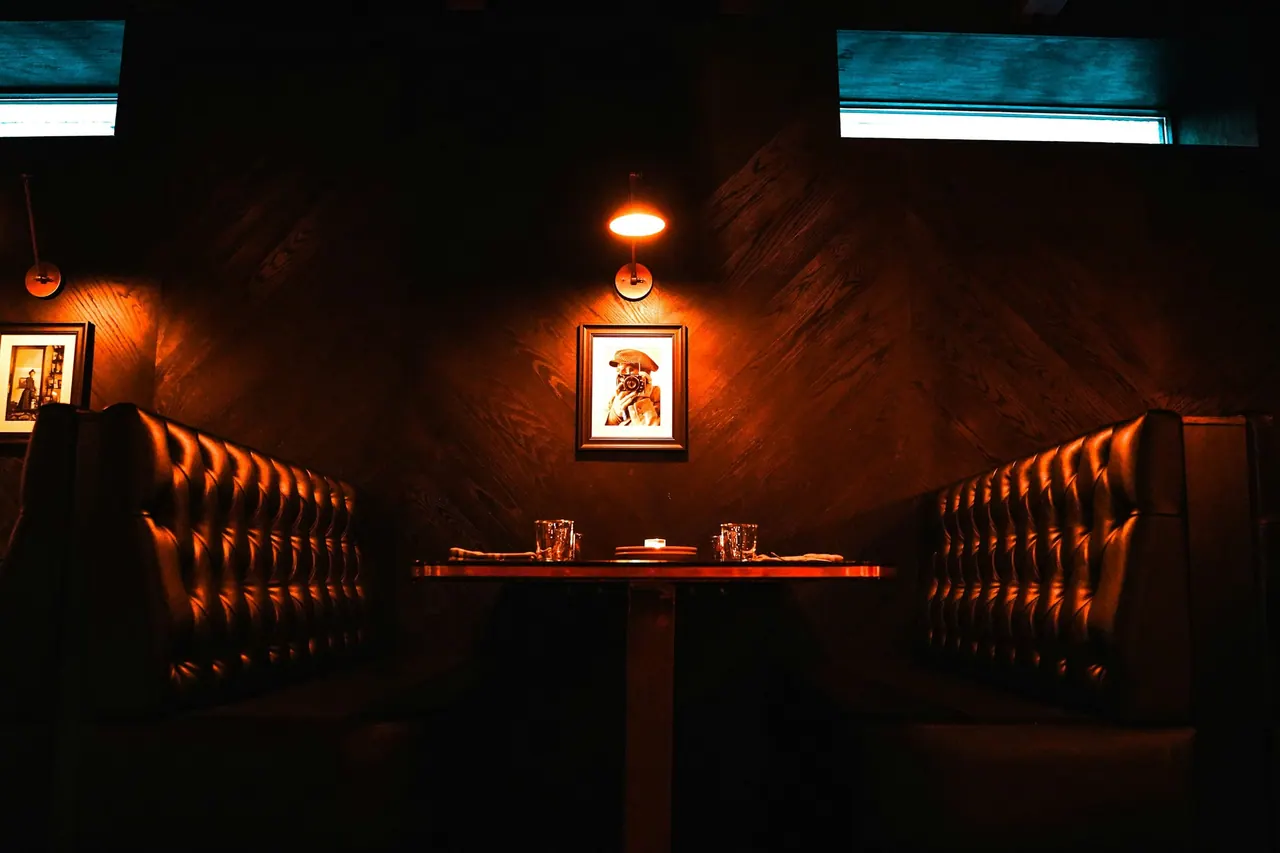 Quiet leather booths in a dim, warm lounge