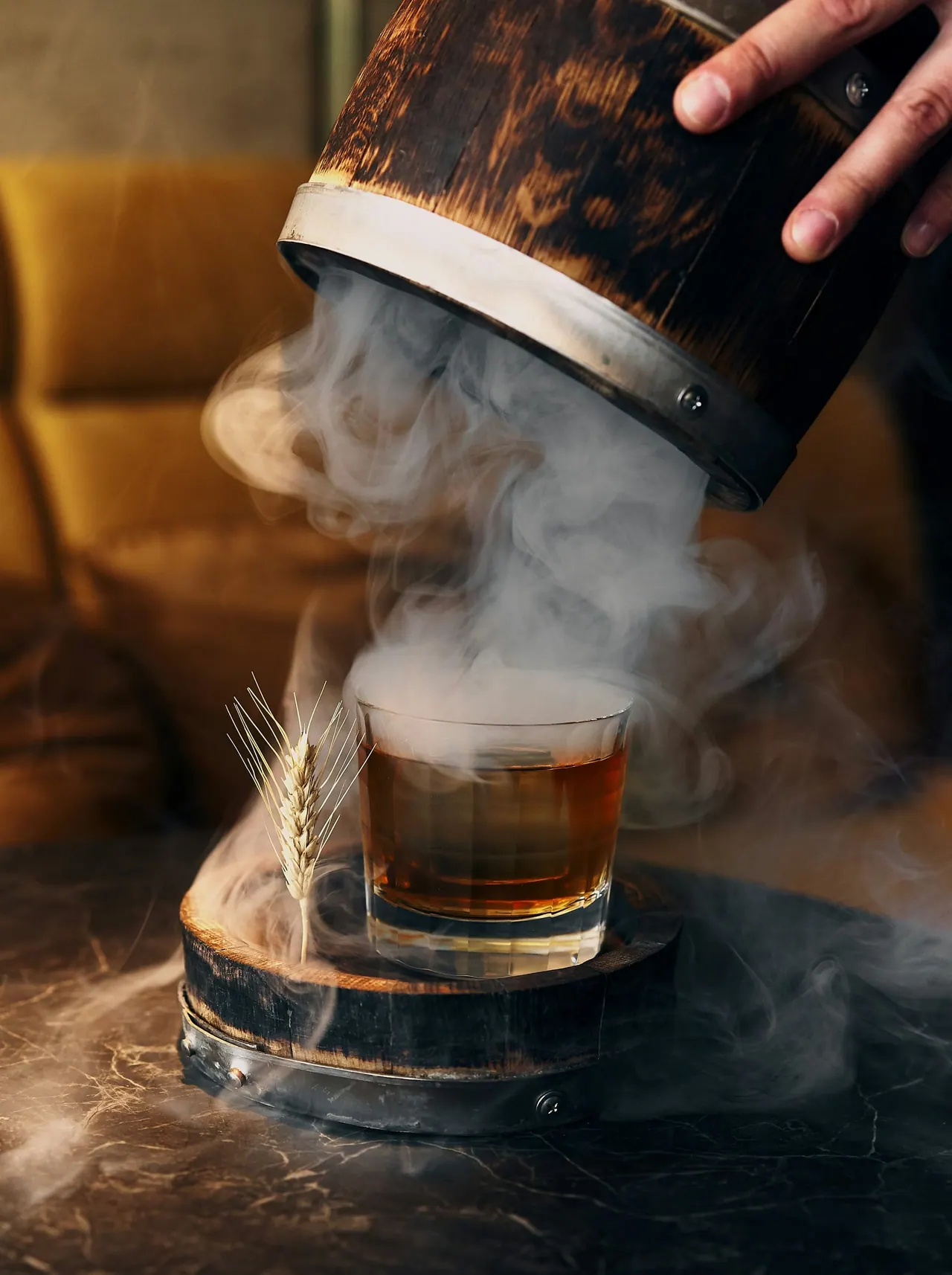 An old fashioned smoking under a wooden cloche