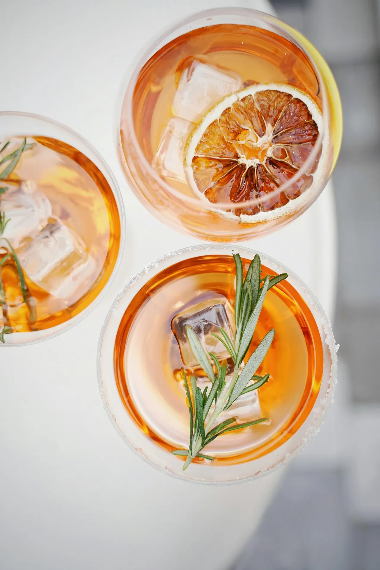 Orange cocktails with rosemary, seen from above