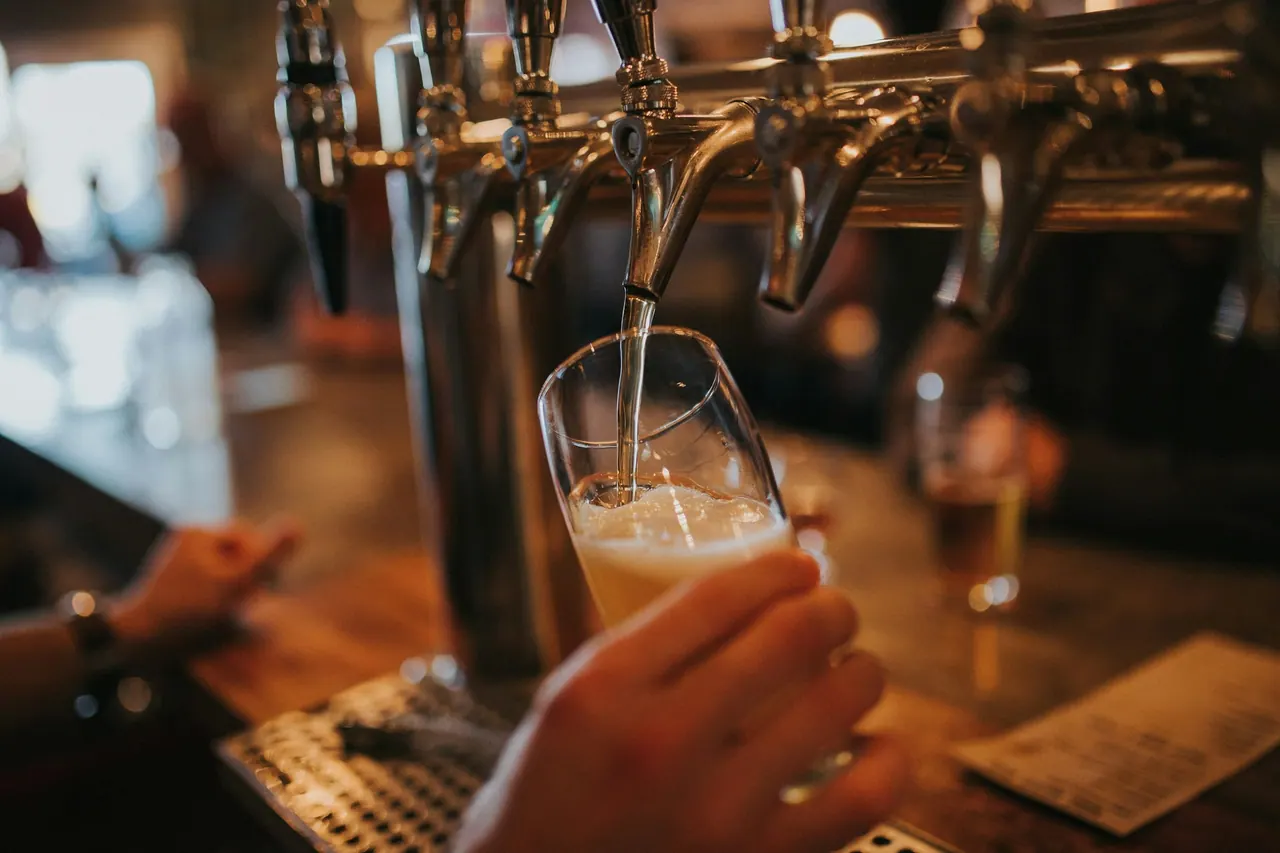 A pint being poured from the tap at the bar