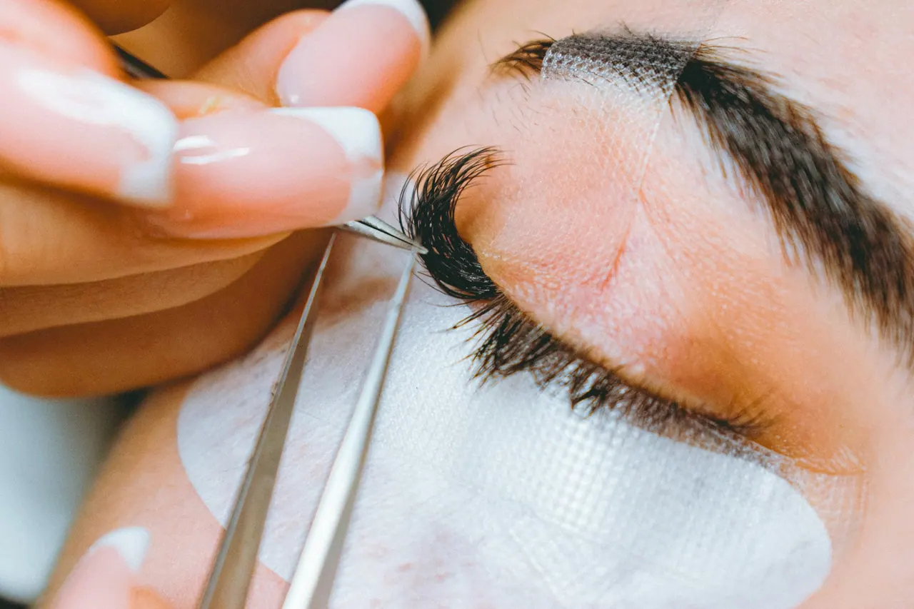 Lash extensions placed with fine tweezers