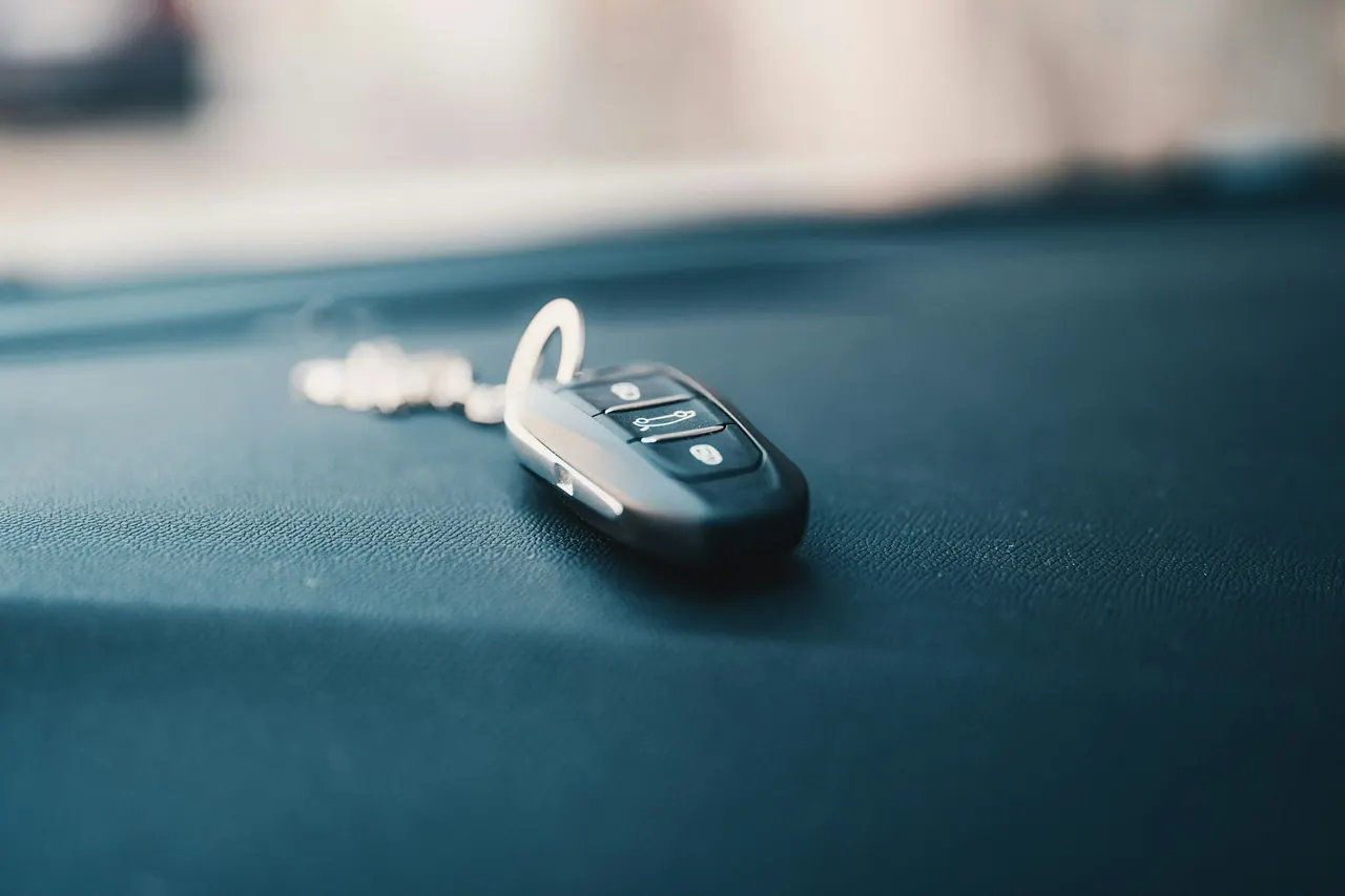 A car key fob resting on a dashboard
