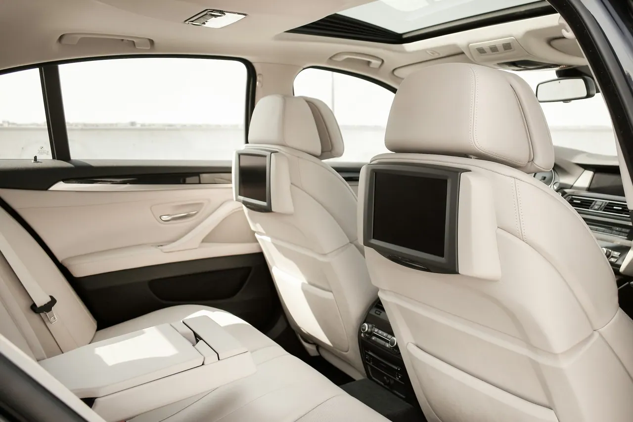 The cream leather rear seats with screens in the headrests