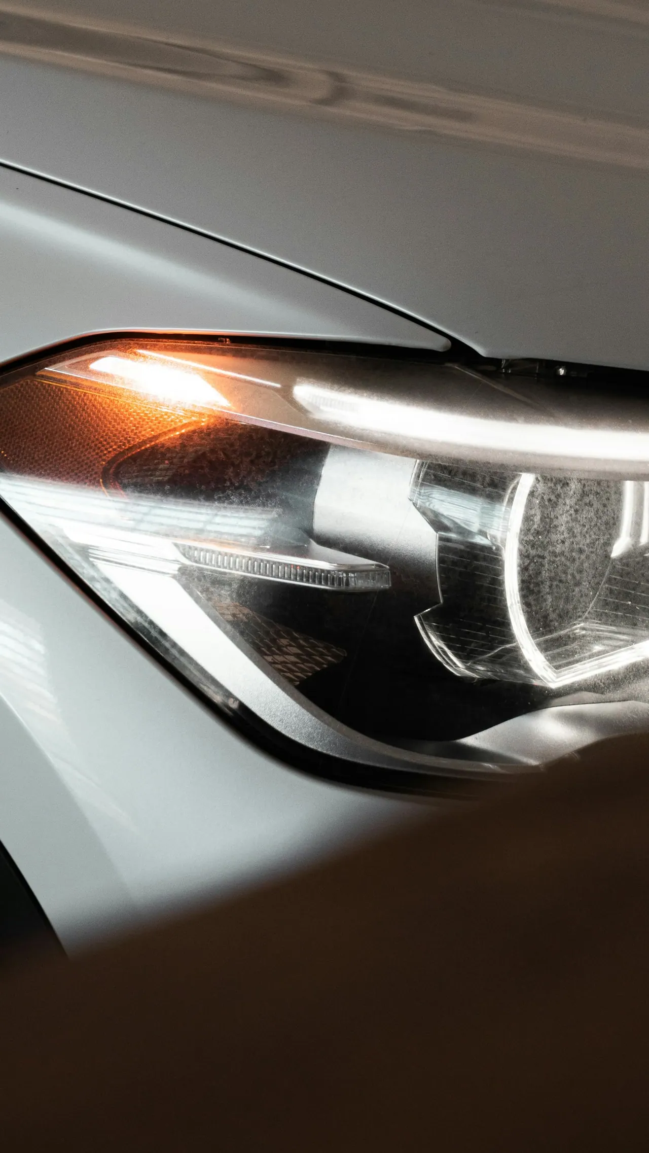 A silver headlight with an amber signal