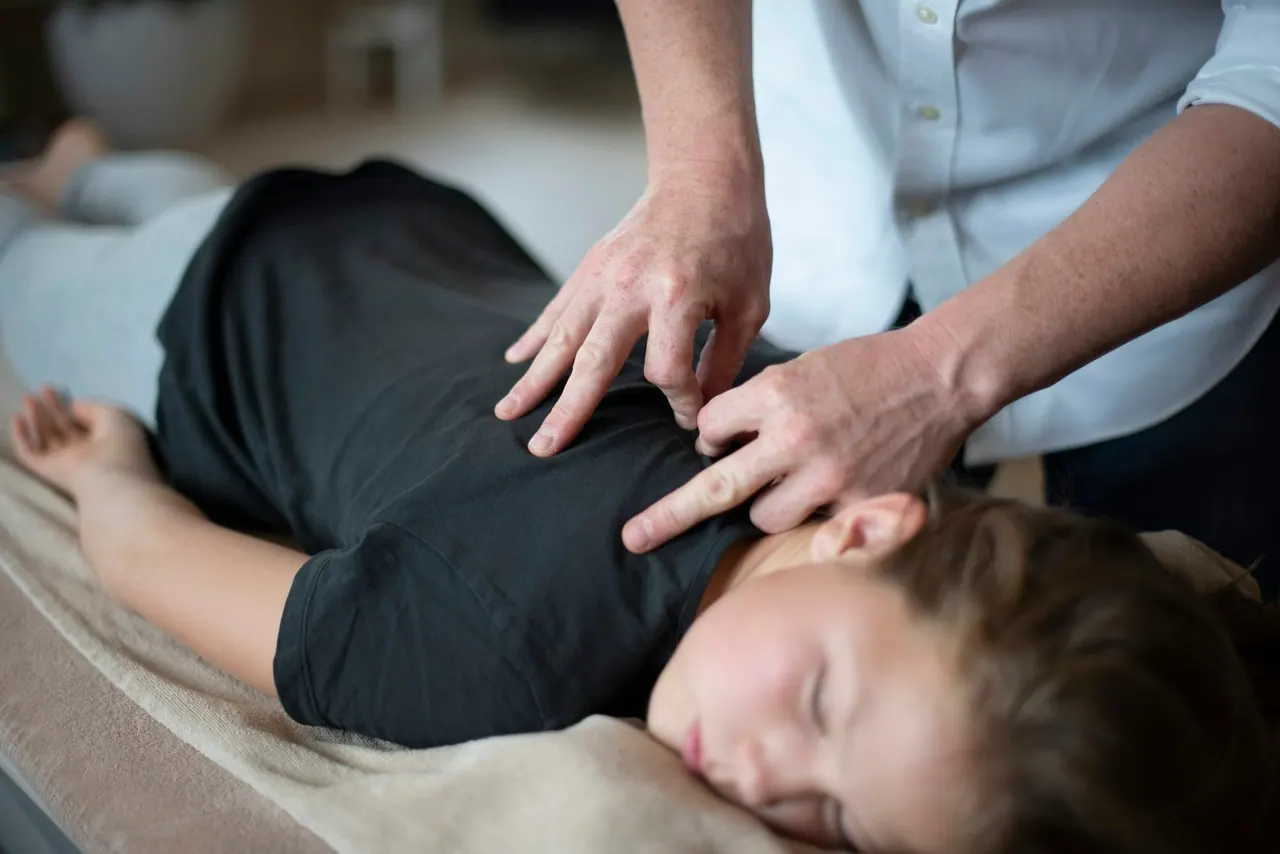 A chiropractor gently treating a relaxed patient's neck
