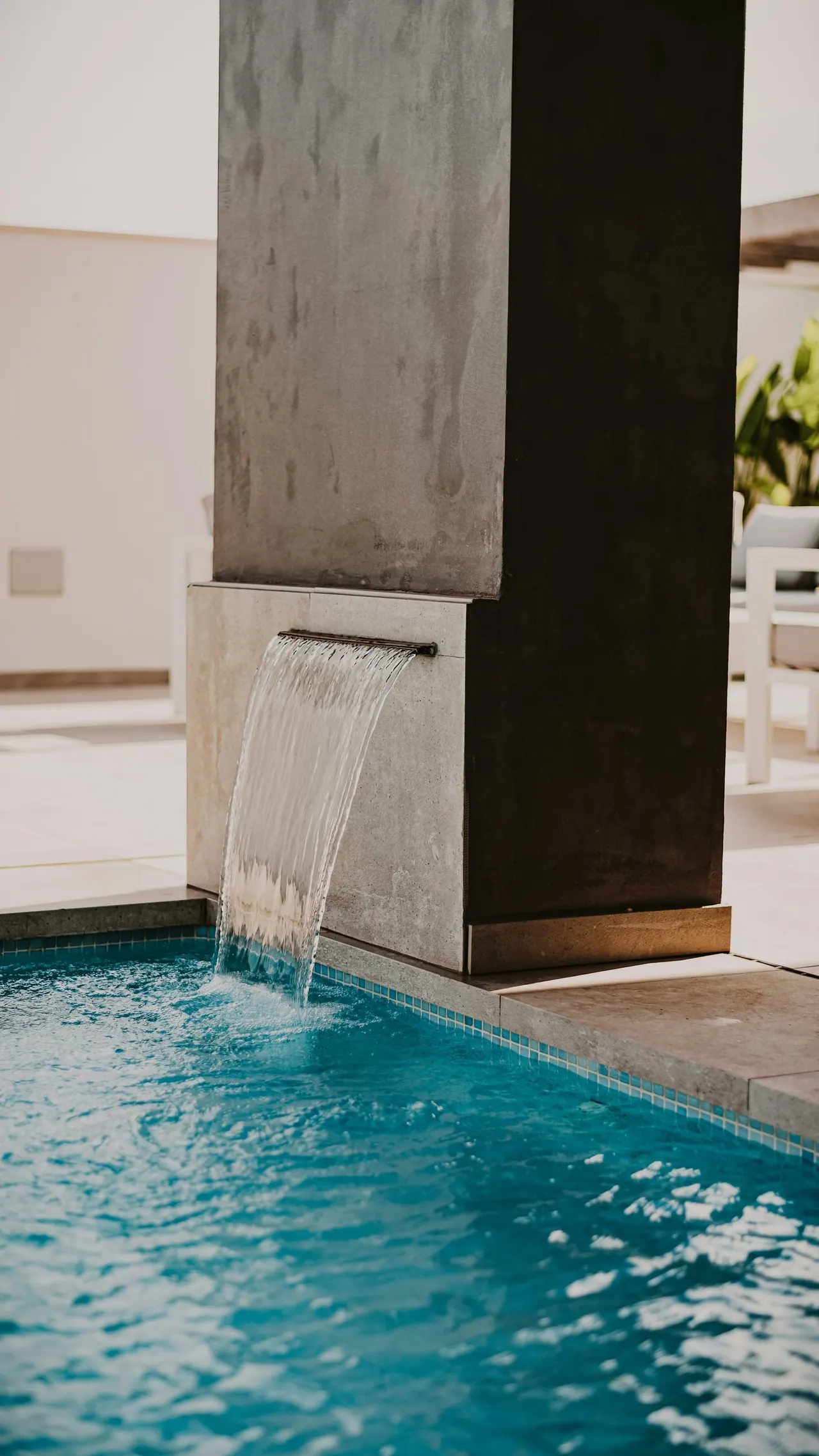 A spa pool with a stone water spout