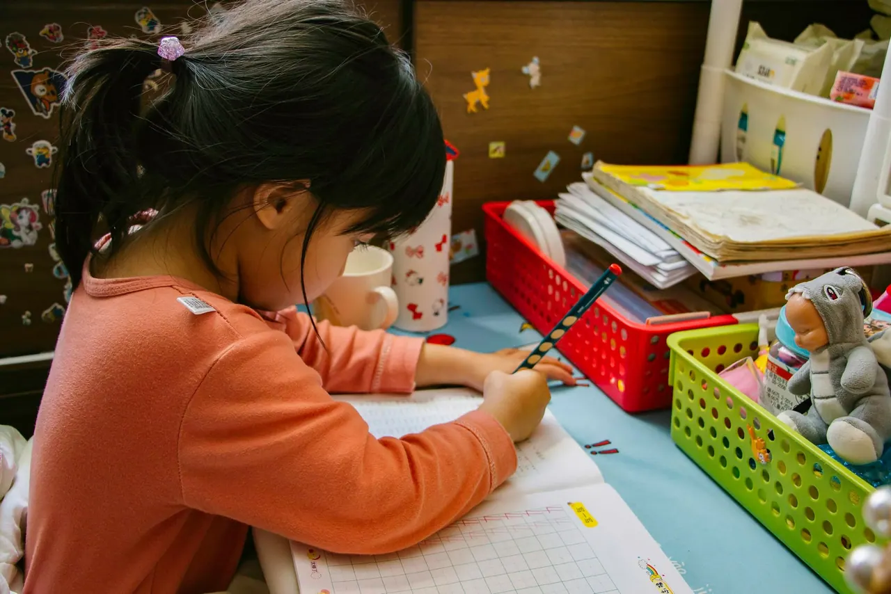 A girl writing at a desk