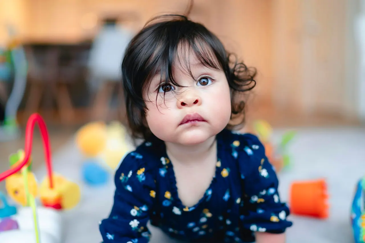 A curious toddler looking at the camera