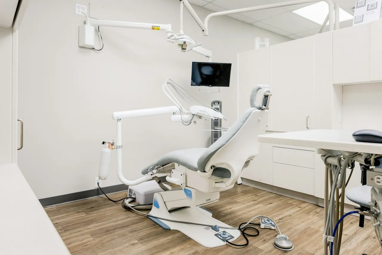 A bright, welcoming treatment room with a white dental chair