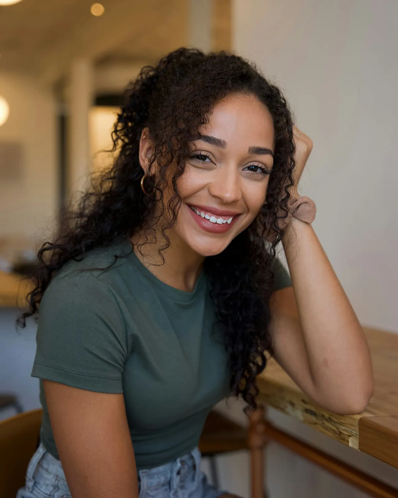 The senior colourist with long curly hair, smiling