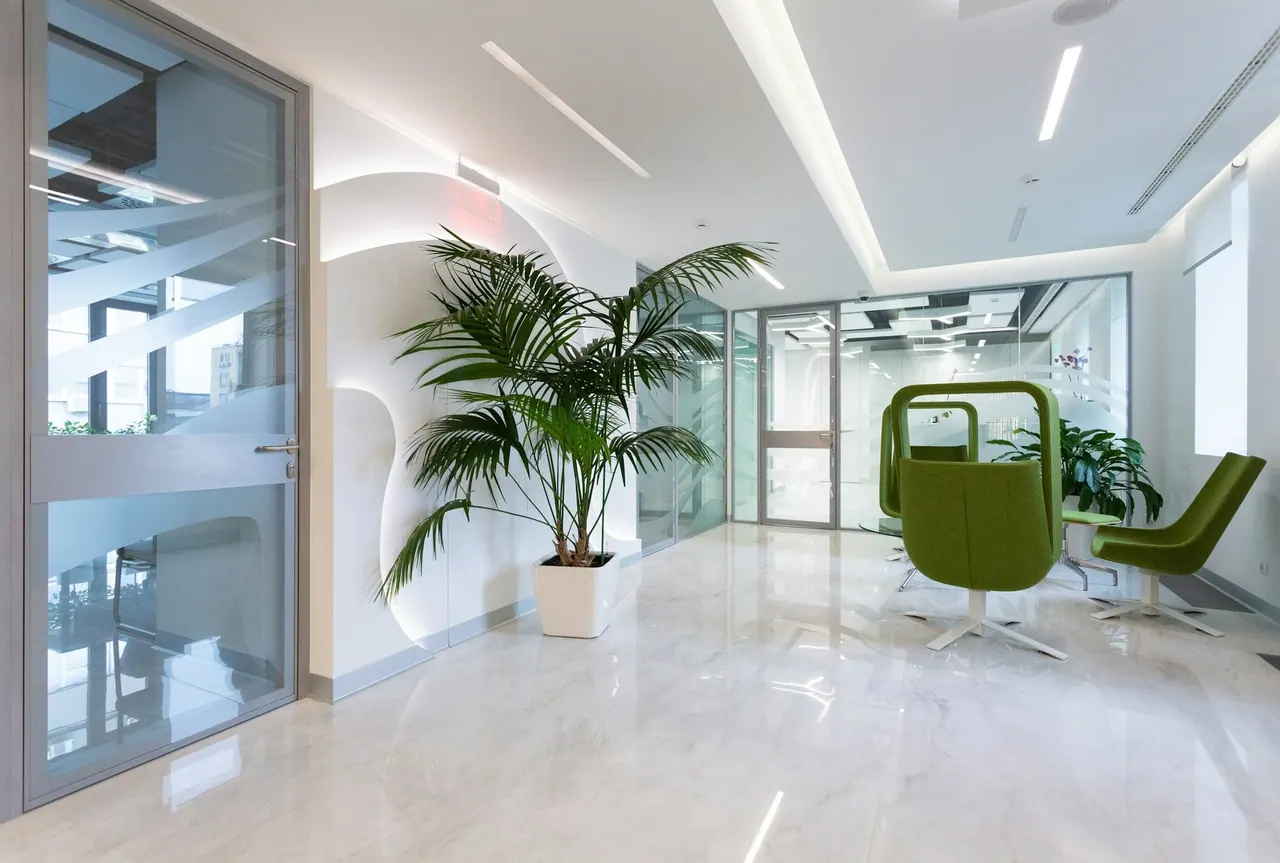 A bright clinic interior with plants and glass doors