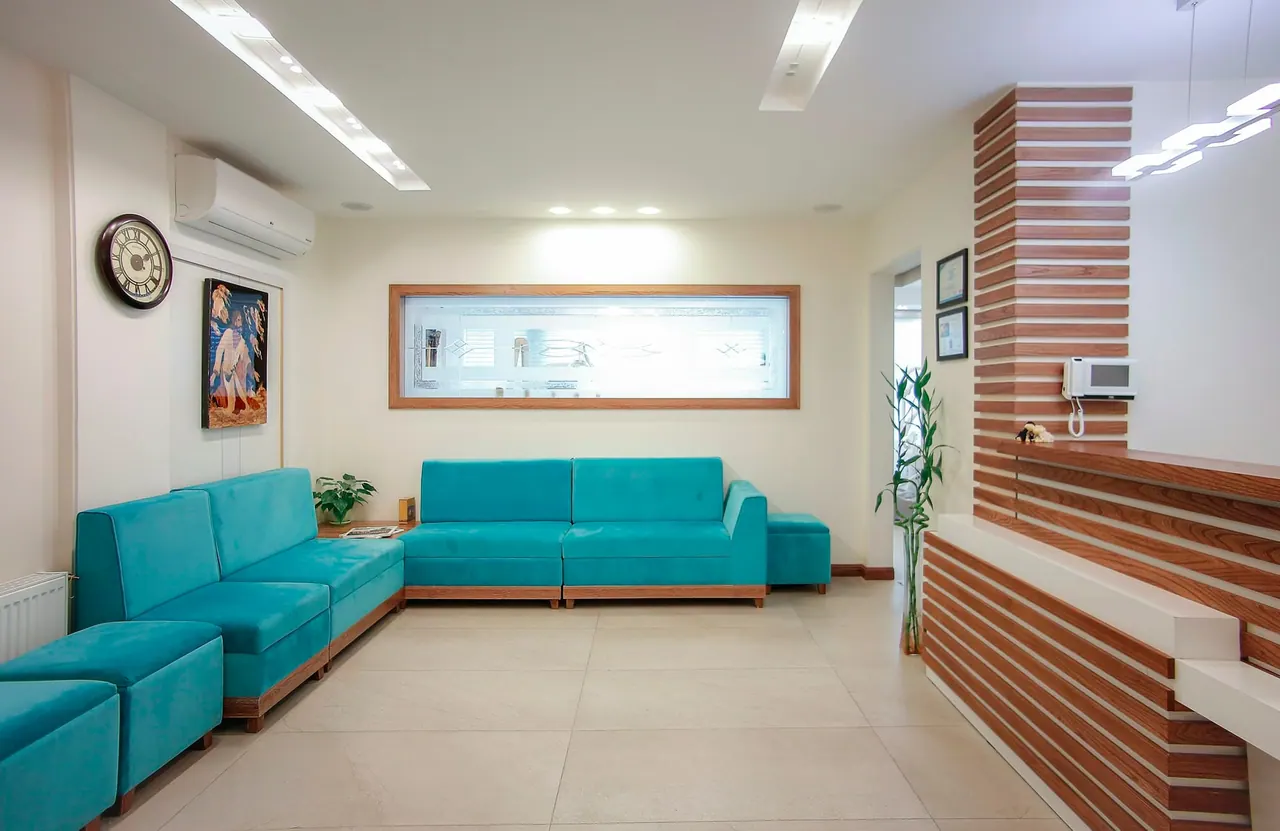 The studio lounge with soft teal sofas