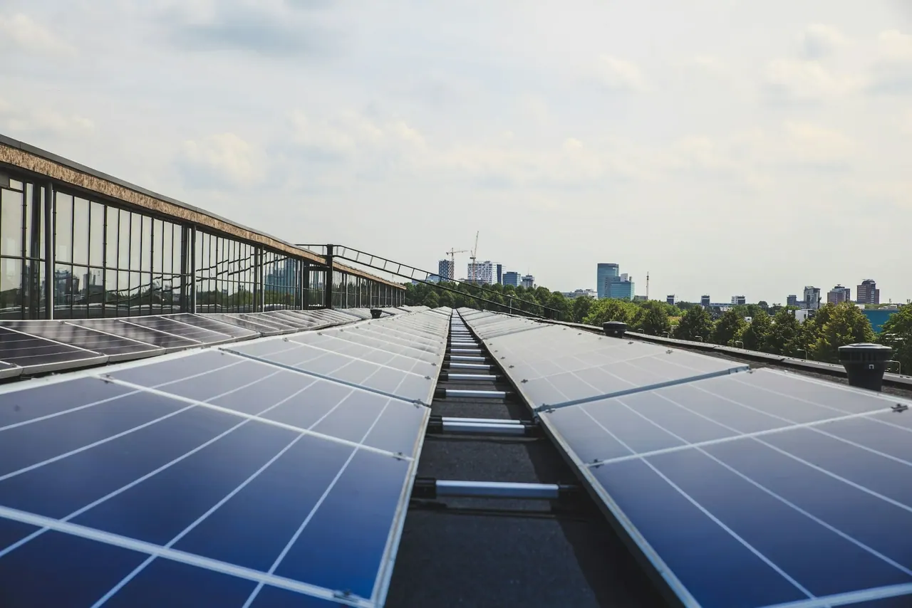 Rows of solar panels on a flat office roof