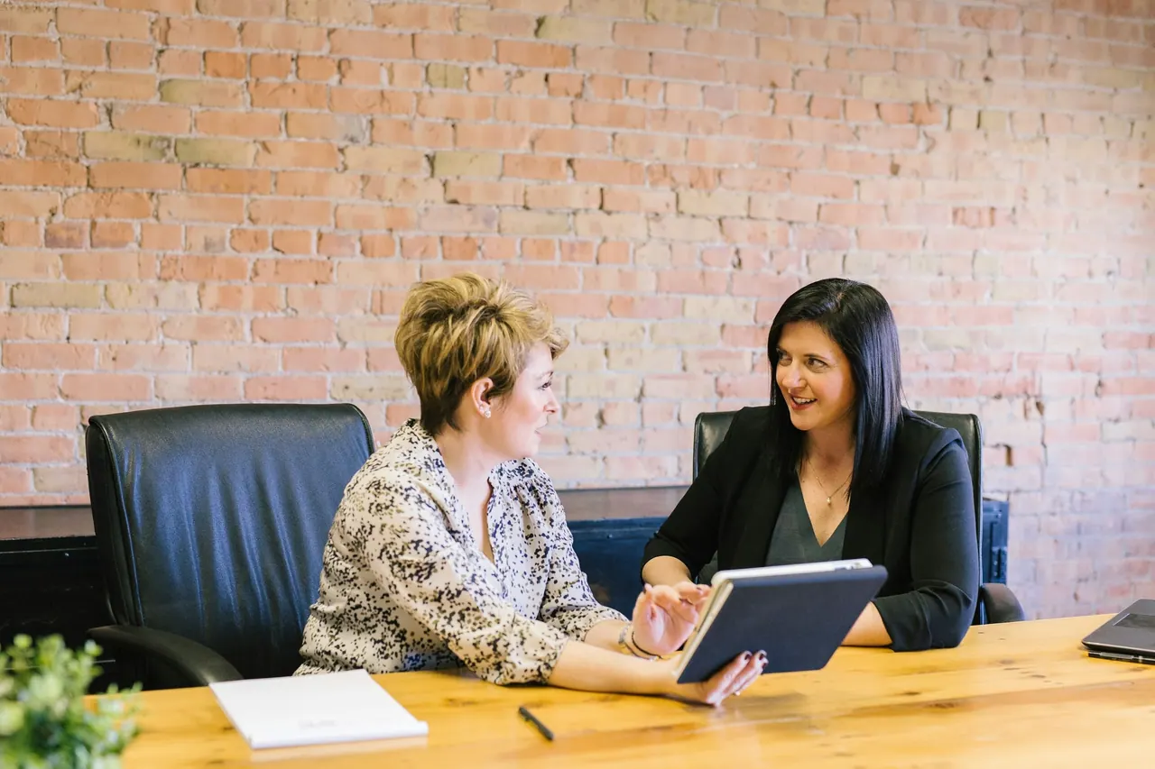 Two women reviewing a financial plan together on a tablet