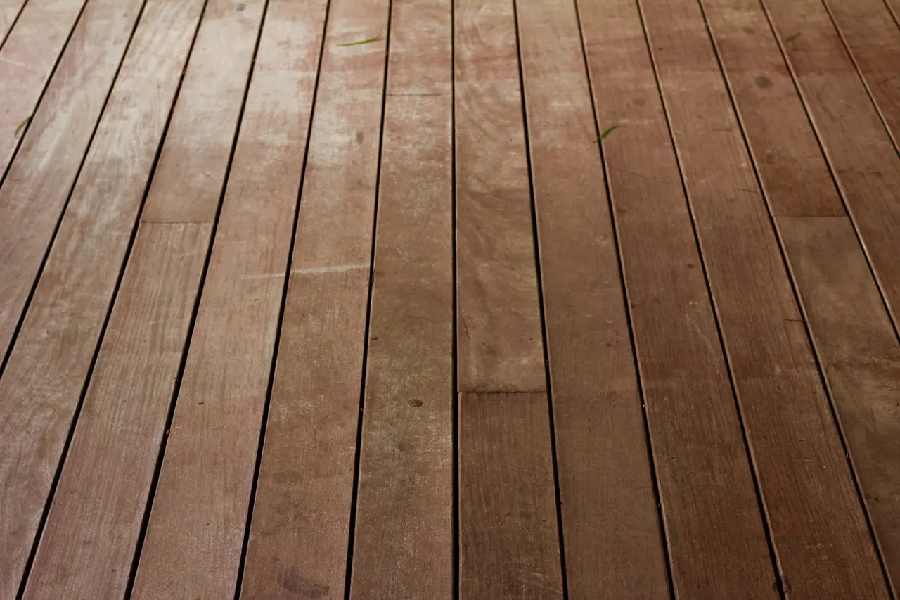 Weathered wooden floorboards up close