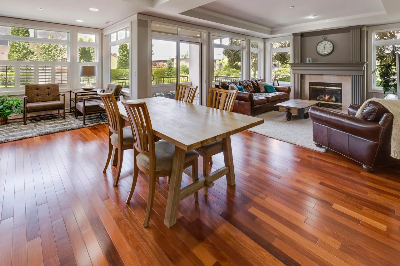 A dining room with rich hardwood floors and a fireplace