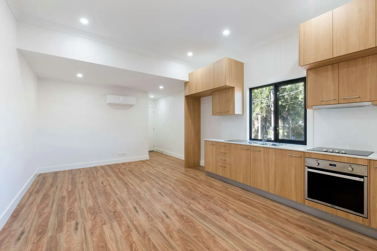 A new kitchen and living room on light engineered wood floors
