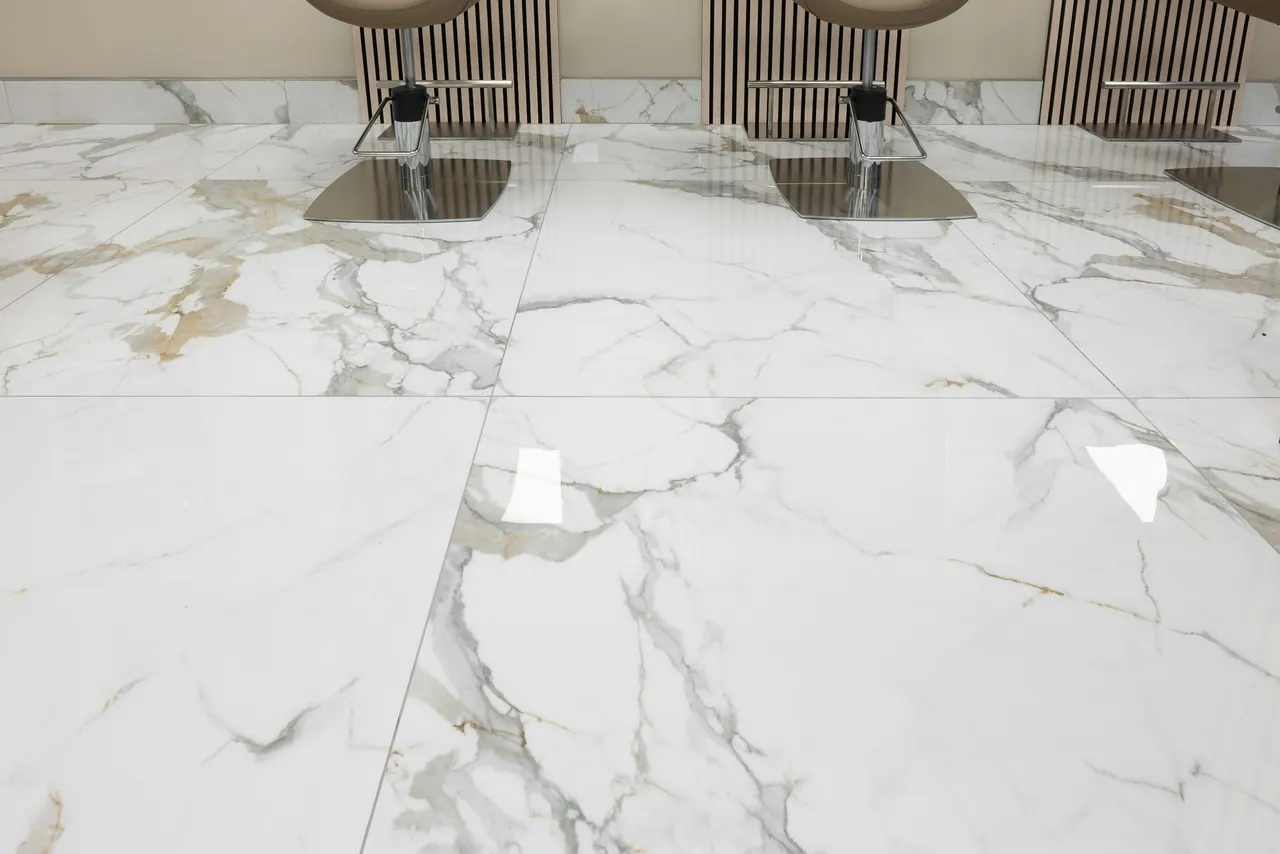 A polished white marble floor with soft grey veins