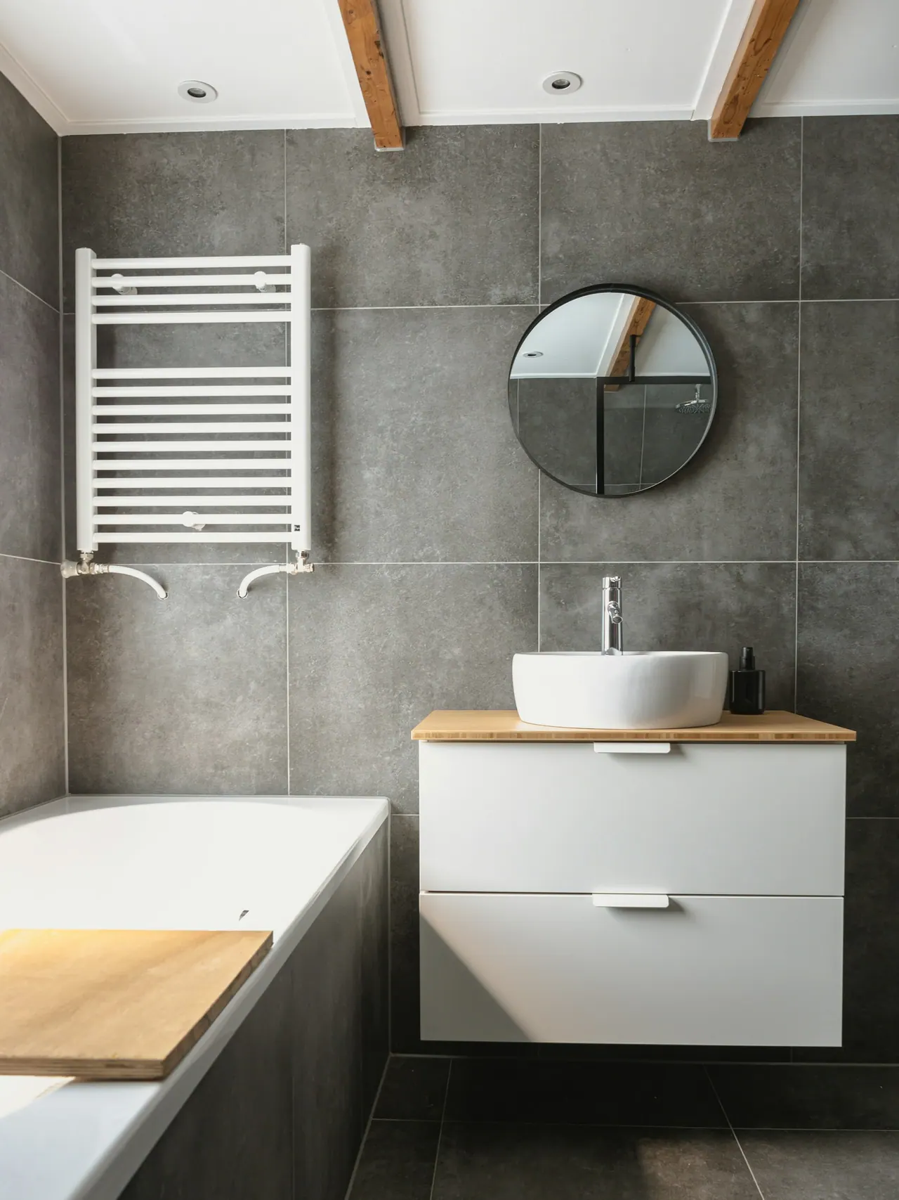 Large charcoal porcelain tiles on a bathroom wall
