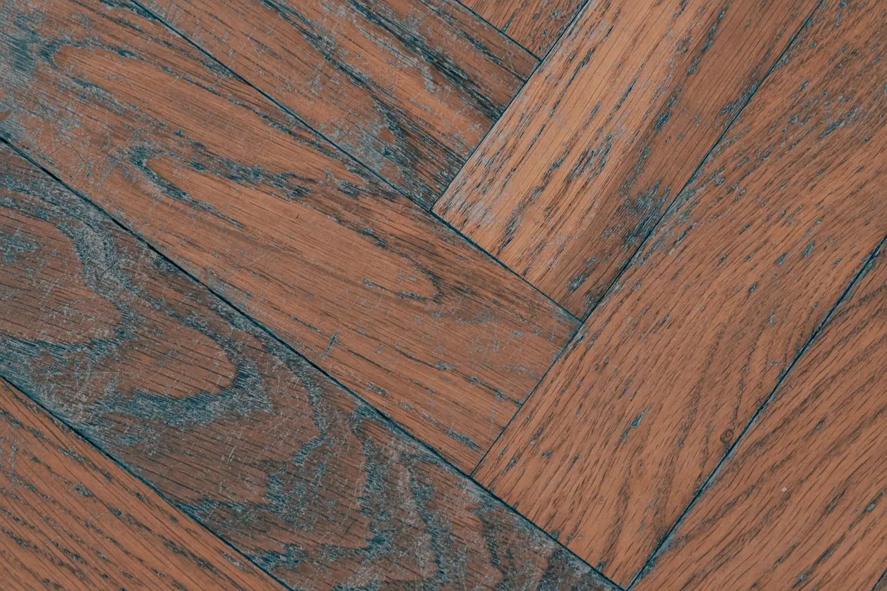 Deep reddish oak grain in a herringbone floor, close up