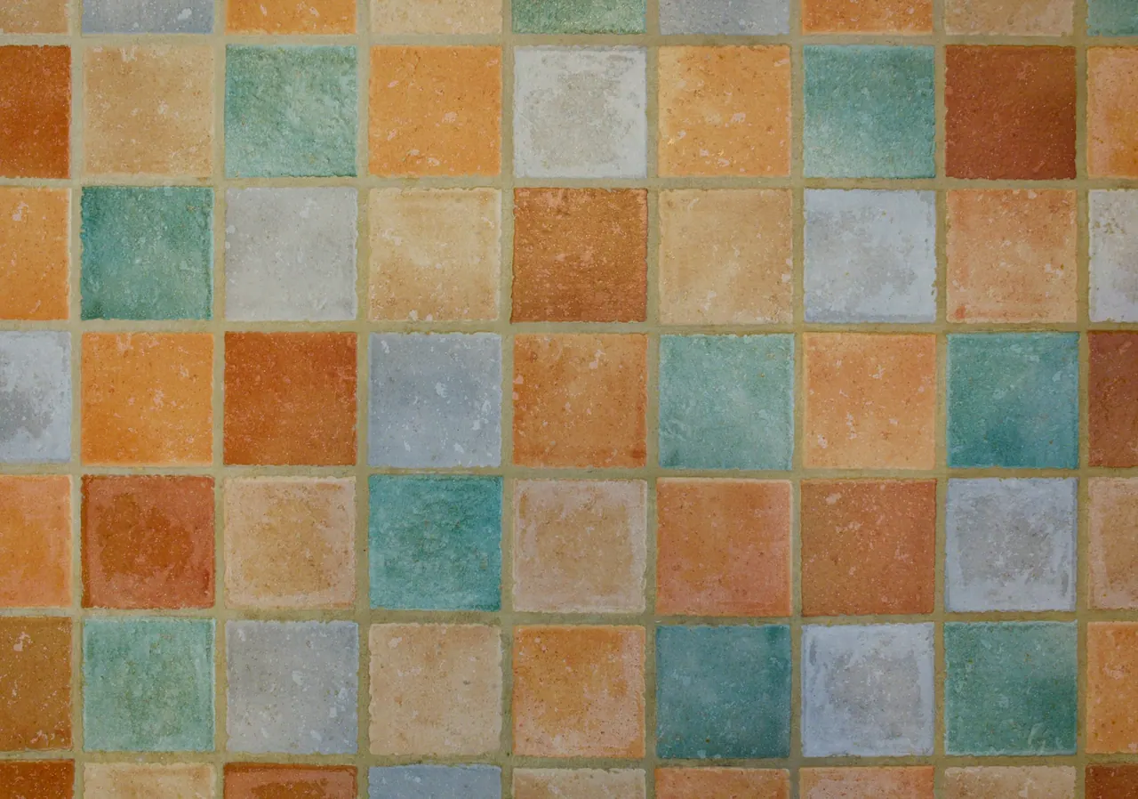 Handmade square tiles in terracotta, apricot, teal and grey
