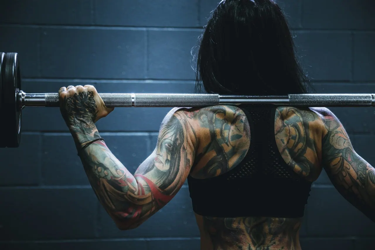 A lifter holding a barbell across her shoulders