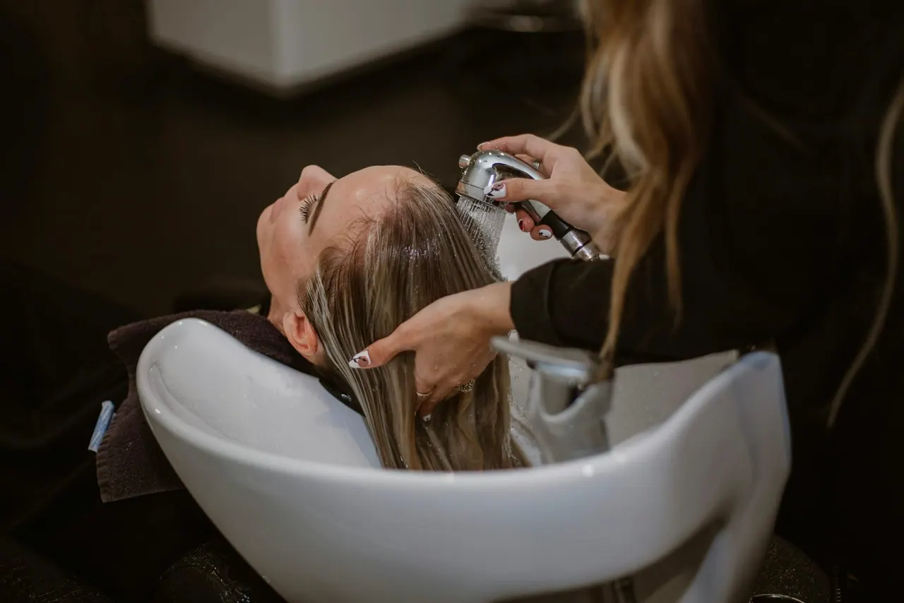 A client relaxing at the basin during a hair wash