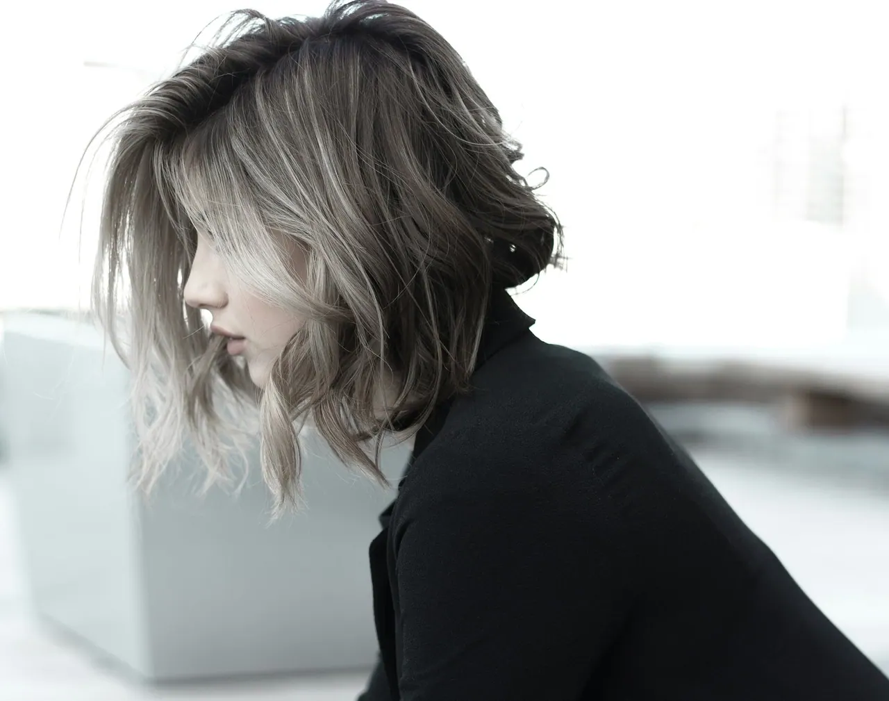 A woman with a short, softly waved silver bob