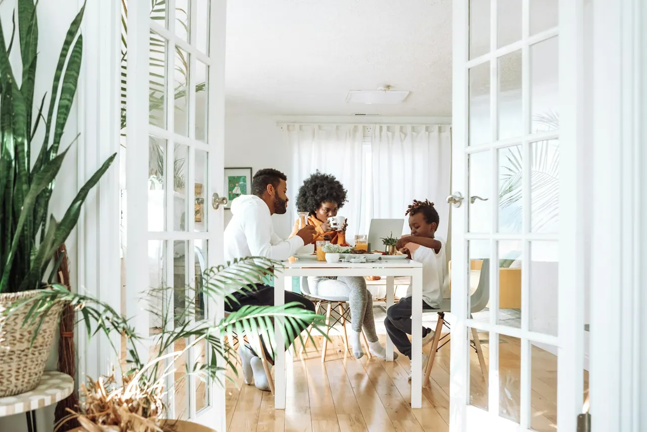 A family sharing a meal at a bright dining table