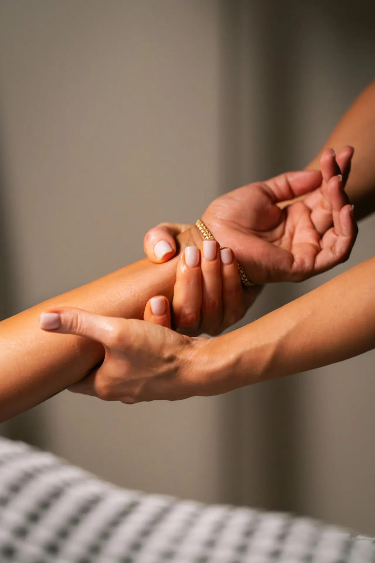 Hands massaging a client’s forearm