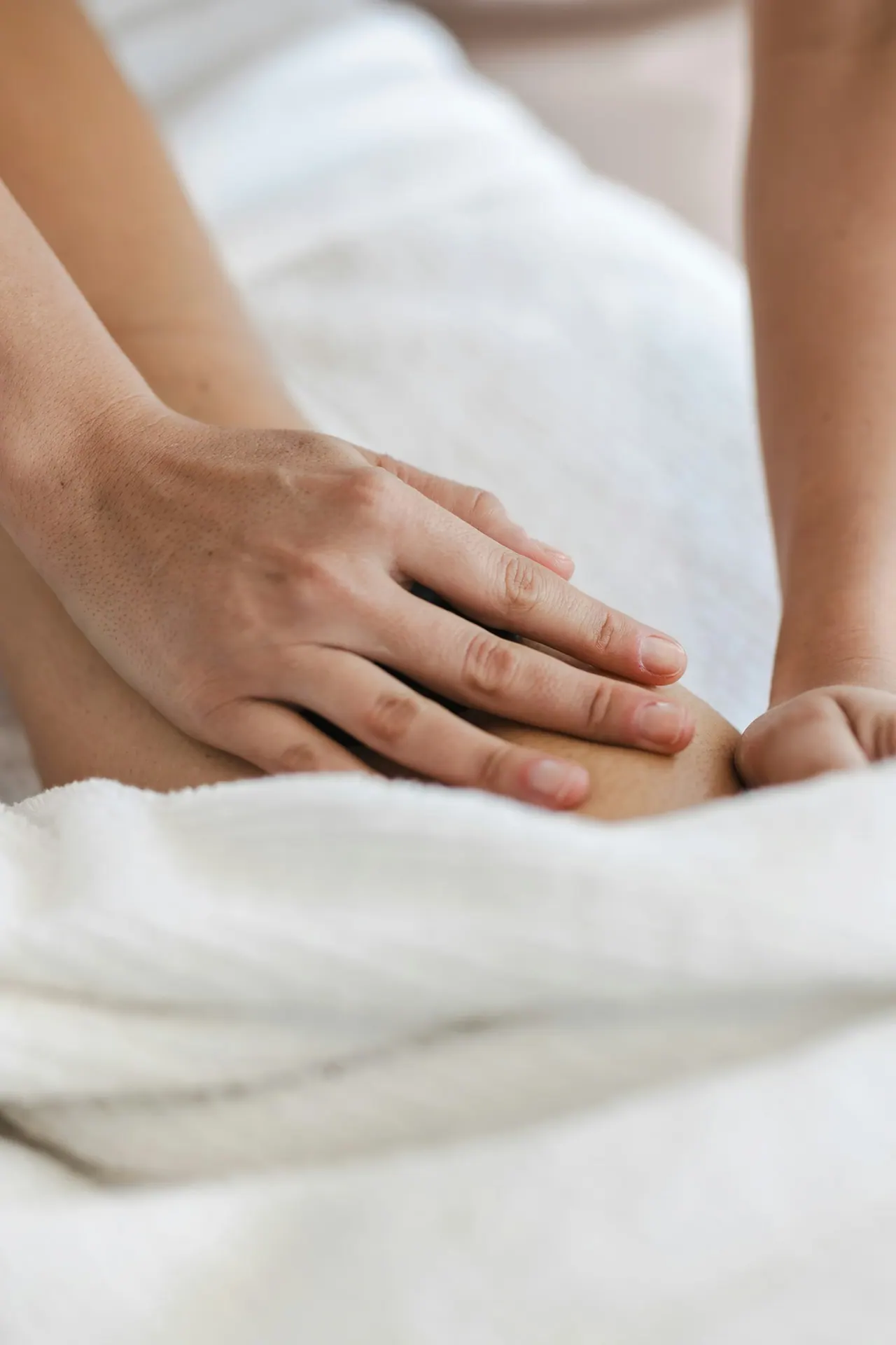 A therapist working slowly along a client’s shoulder blade