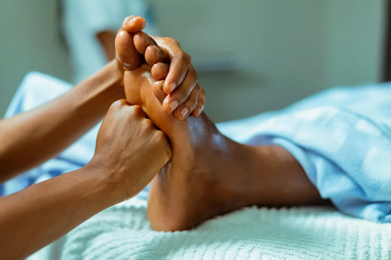A therapist giving a gentle foot massage