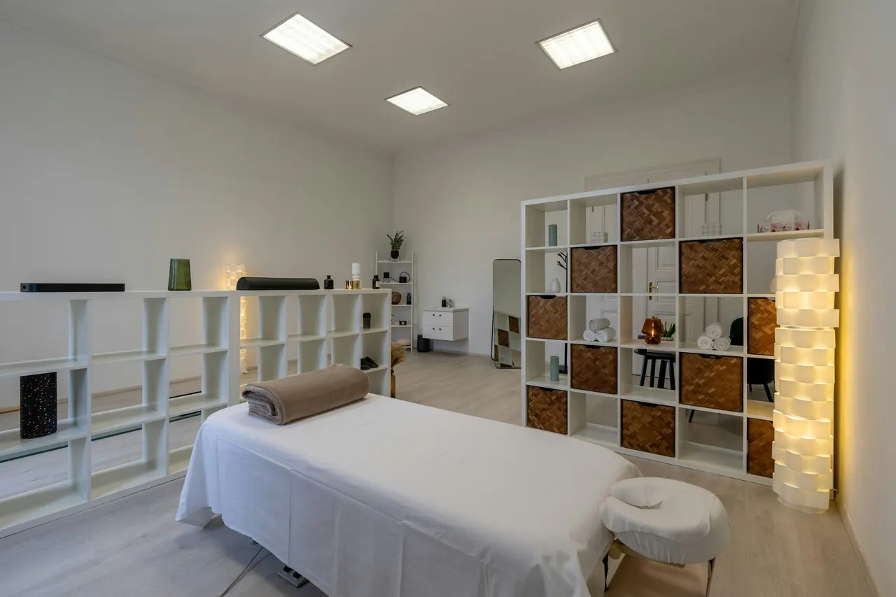 A bright, clean treatment room with a massage table