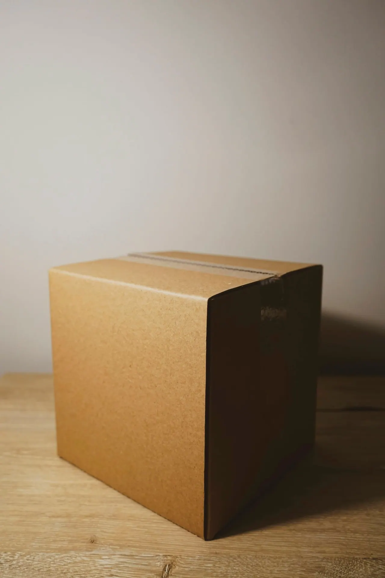 A single cardboard box on a wooden table