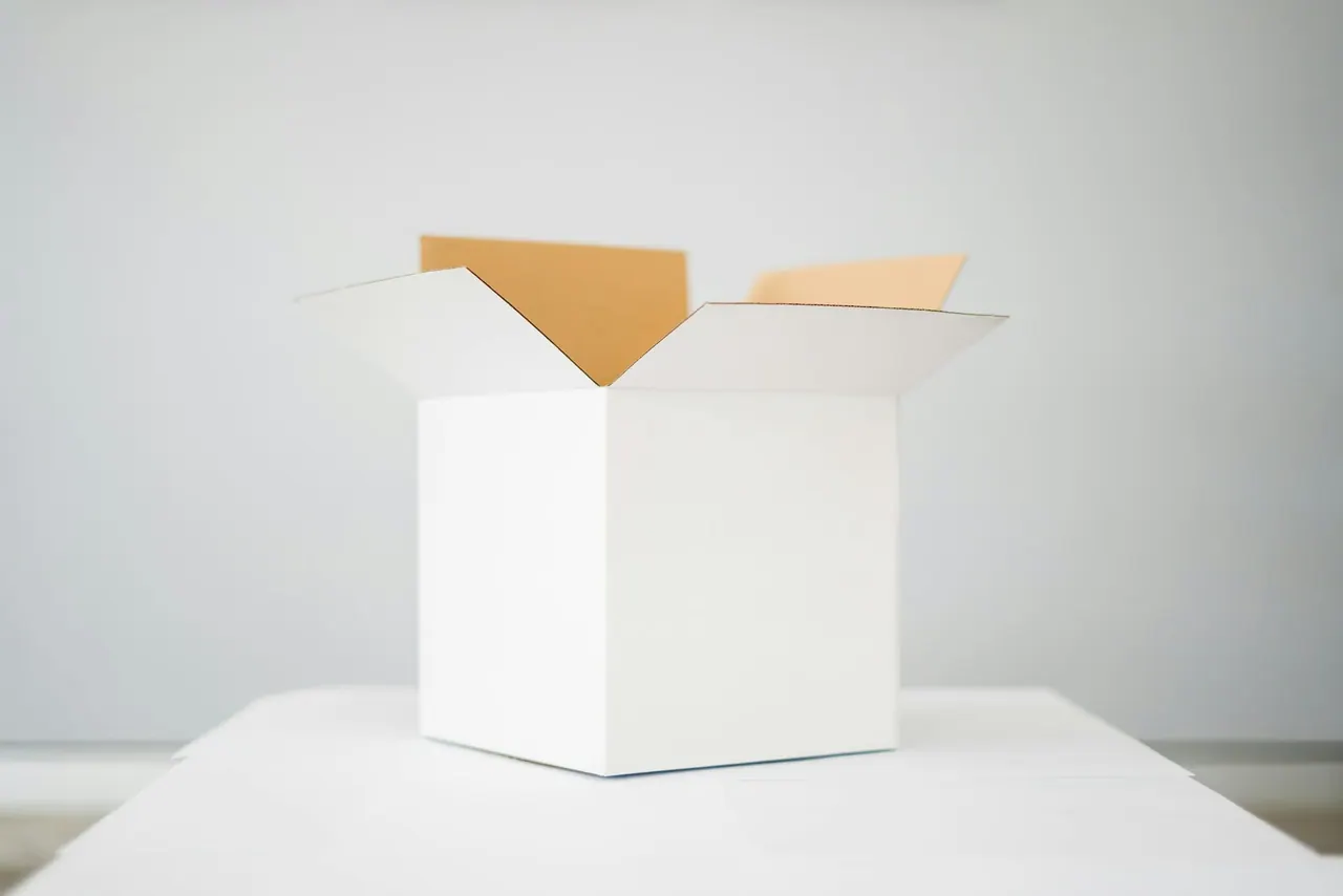 An open white box on a white table