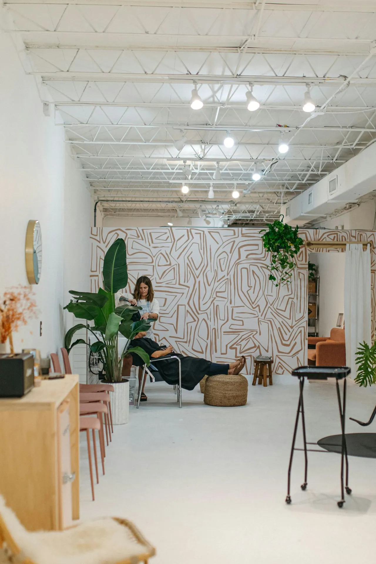 Our bright studio with plants, a lounge chair and a client relaxing