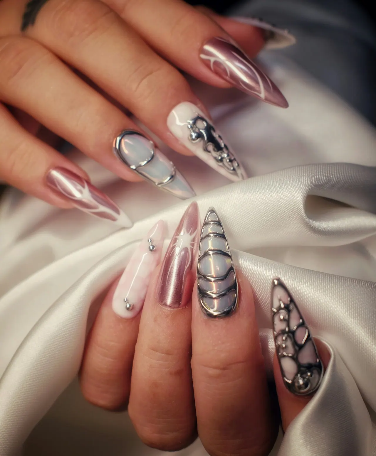 Long almond nails in chrome with jewelled art