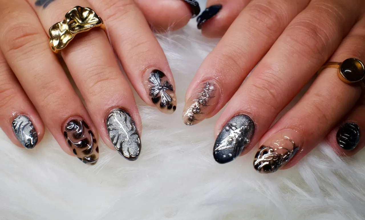 Silver and black nail art with gold rings