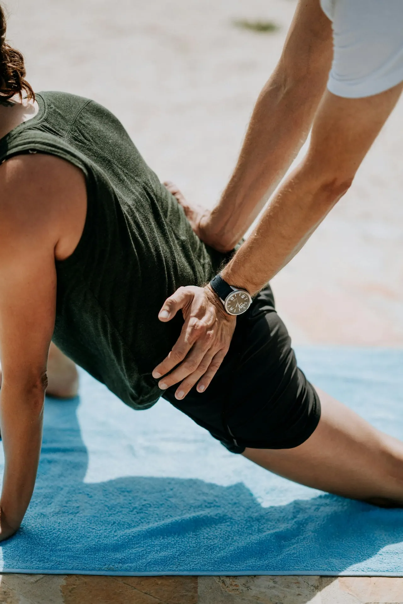 A hip stretch guided on a soft mat