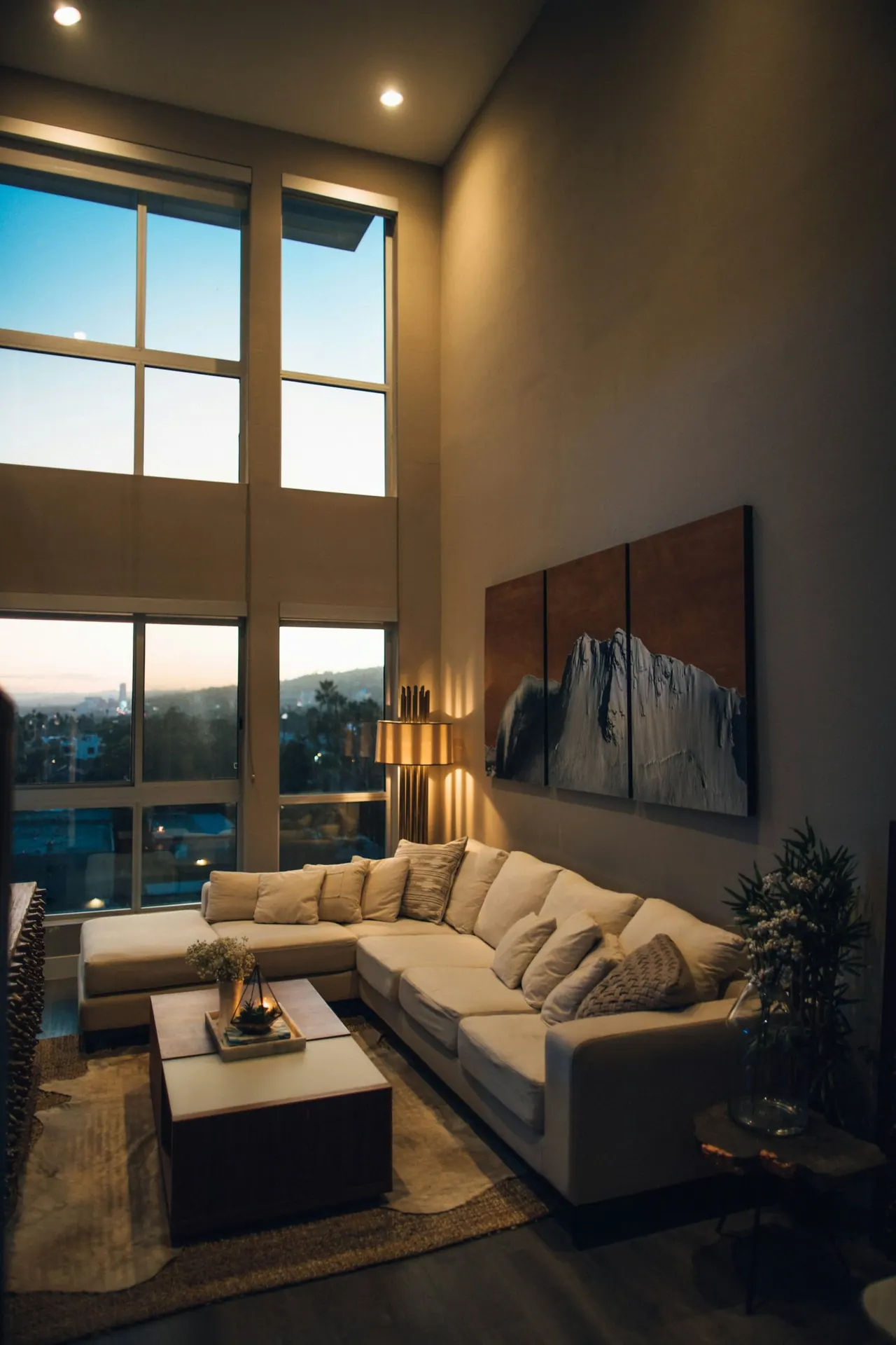 A double height living room lit by a tall window