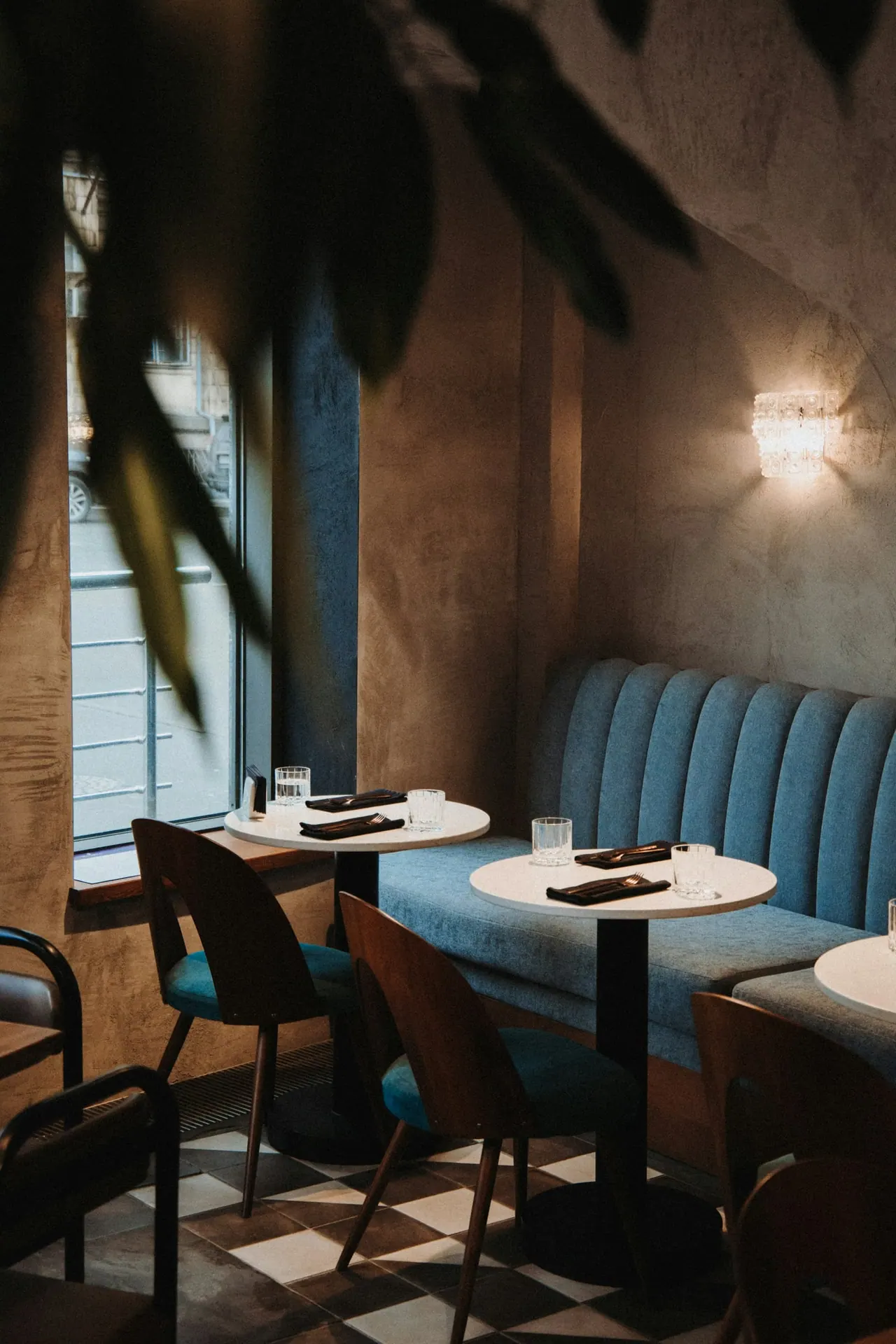 A round table set for dinner in a softly lit dining room