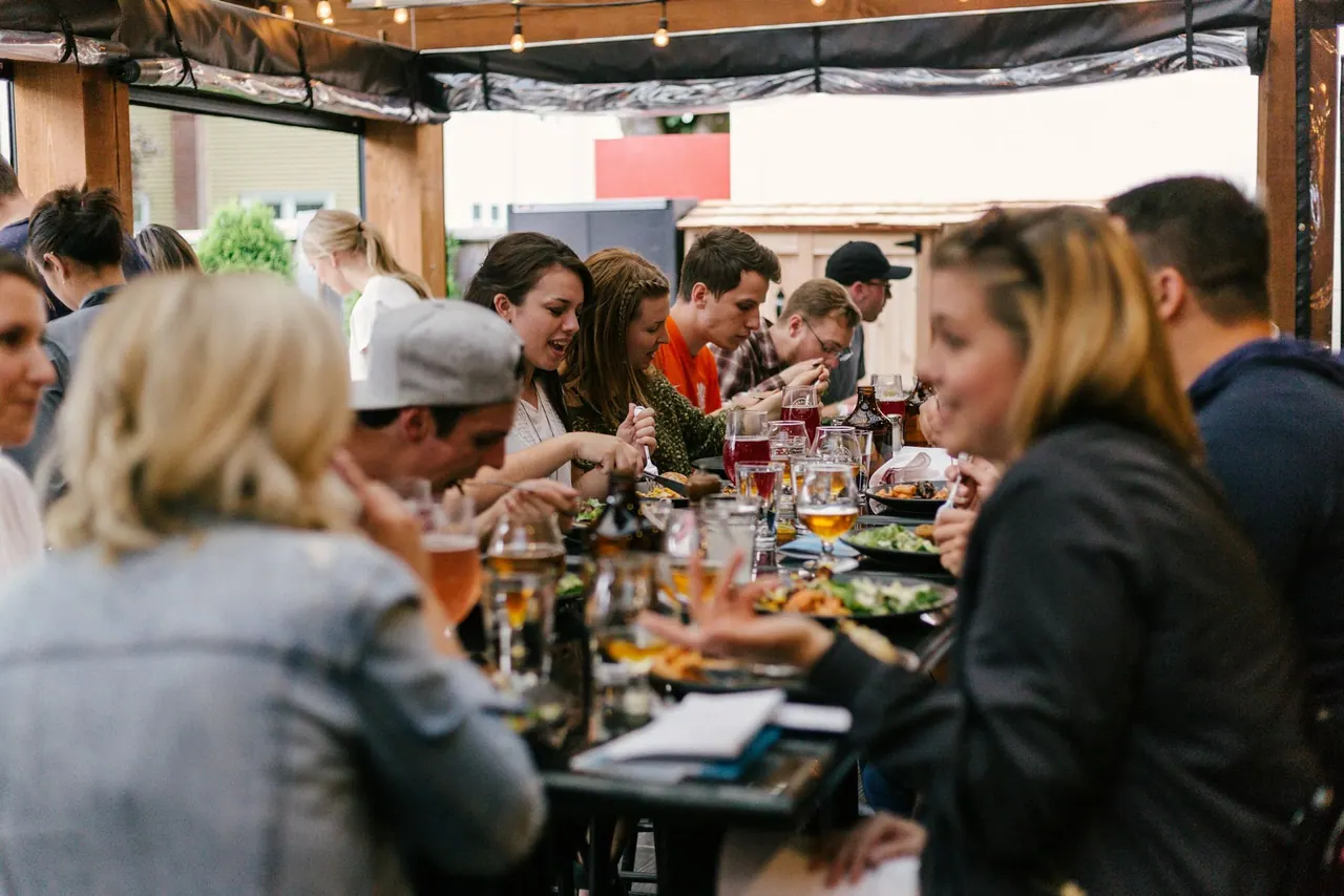 Friends talking and laughing around a busy table