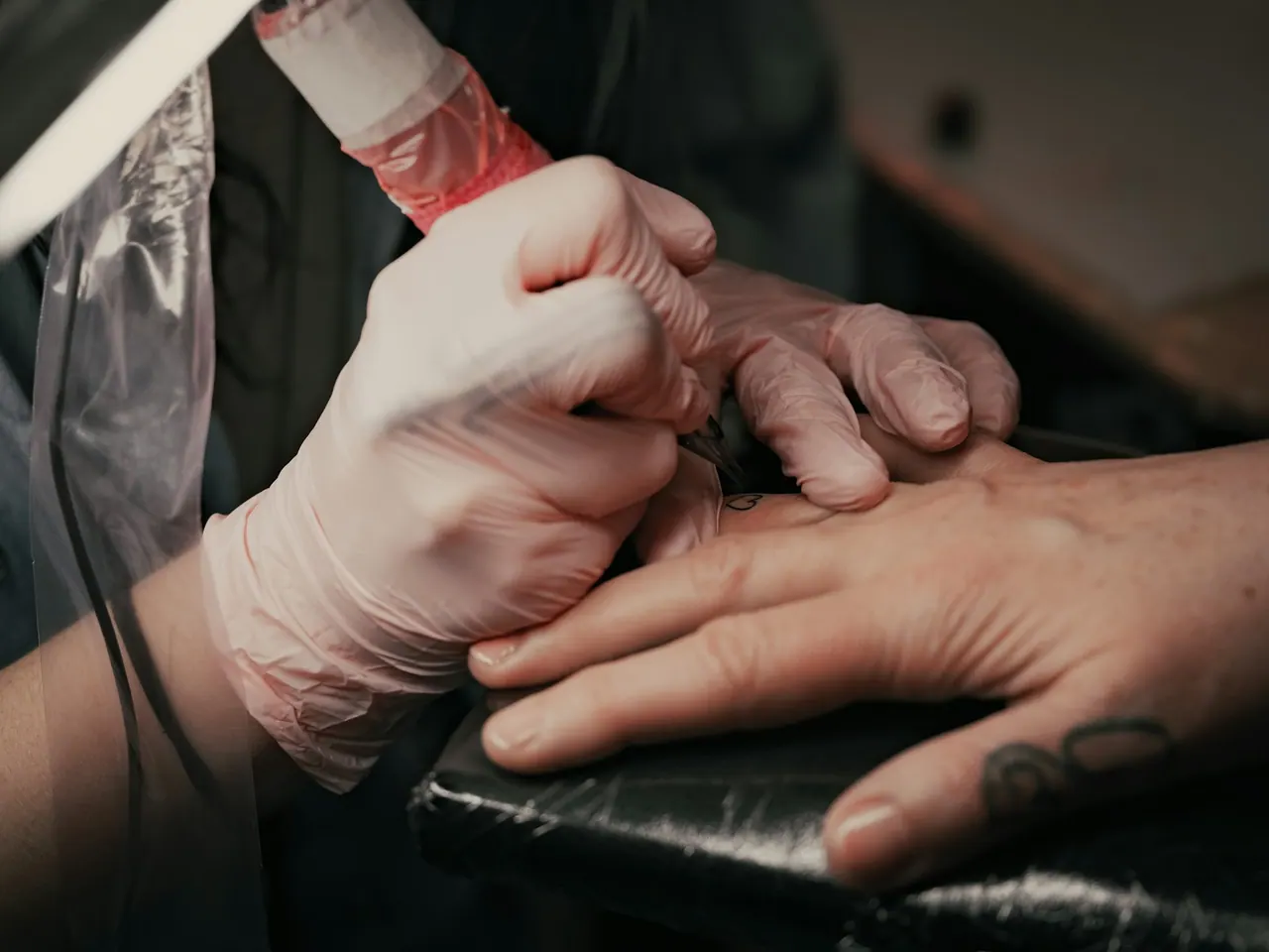 A small custom hand tattoo in progress