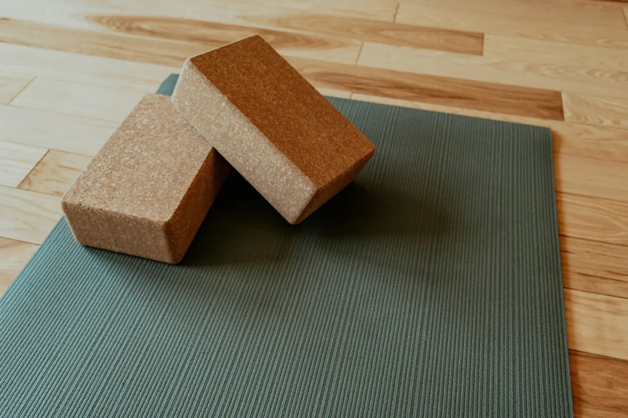 Two cork blocks resting on a sage green mat